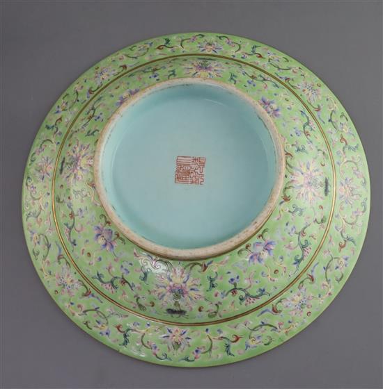 A Chinese lime green ground footed dish, Daoguang seal mark and of the period (1821-1850), D. 25.5cm, section of rim broken and re-stuc